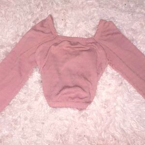 Thin pink long sleeve blouse, worn off and on the shoulders.